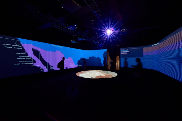 The presentation builds a conversation between the screens on the two long sides of the room.